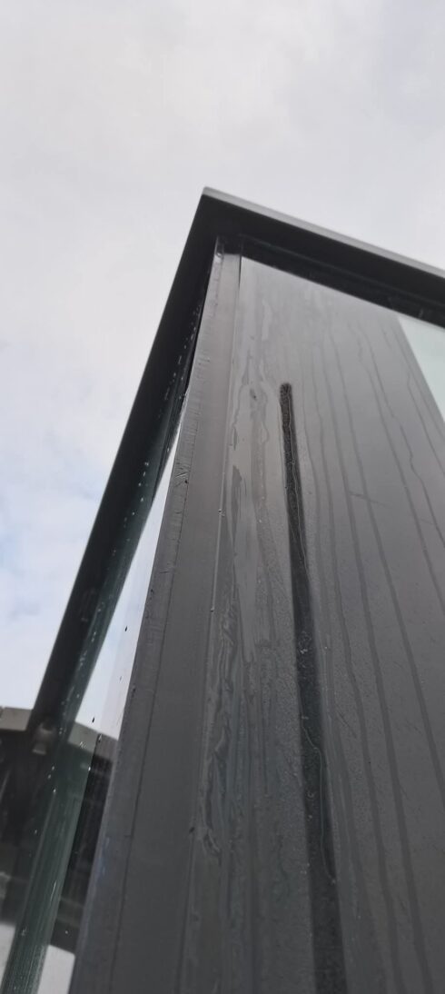 Black metal cladding column viewed from below