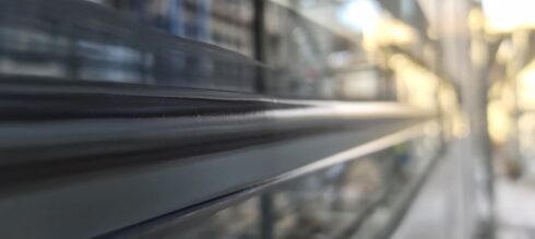 Dark grey aluminium window sill joint, close-up