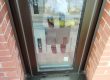 Grey aluminium window in red brickwork with the frame perimeter sealed
