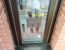 Grey aluminium window in red brickwork with the frame perimeter sealed