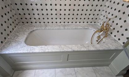 Built-in bath with marble deck, gold taps and black and white tiles, sealed, Bedford