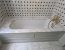 Built-in bath with marble deck, gold taps and black and white tiles, sealed, Bedford