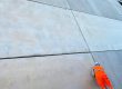 Applicator sealing joints between large precast concrete wall panels at a development in Dagenham, east London