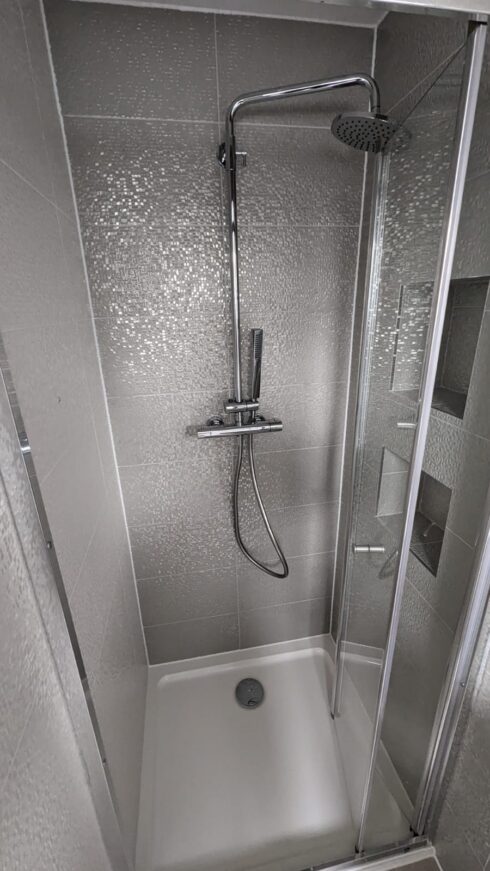Shower enclosure with white tray and grey sparkle tiles, sealed around the tray and screen, Bedford