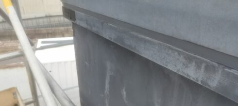 Grey stone coping joint on a pier, scaffold alongside